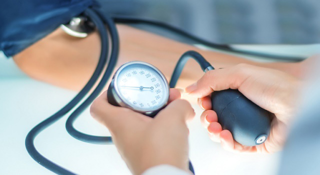 Doctor taking blood pressure