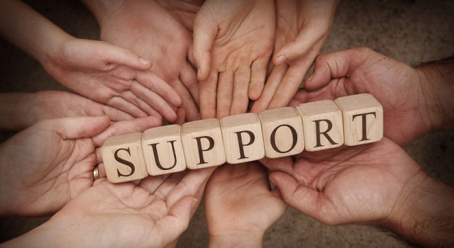 hands holding support sign 