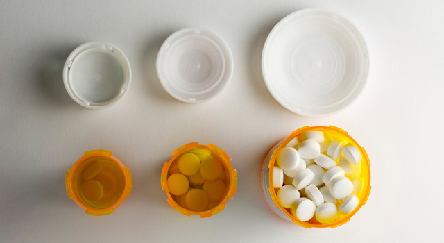 three prescription pill bottles